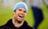 FOX commentator greg olsen laughing while wearing a blue beanie