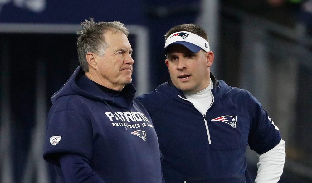 Josh McDaniels talking to Bill Belichick as Patriots