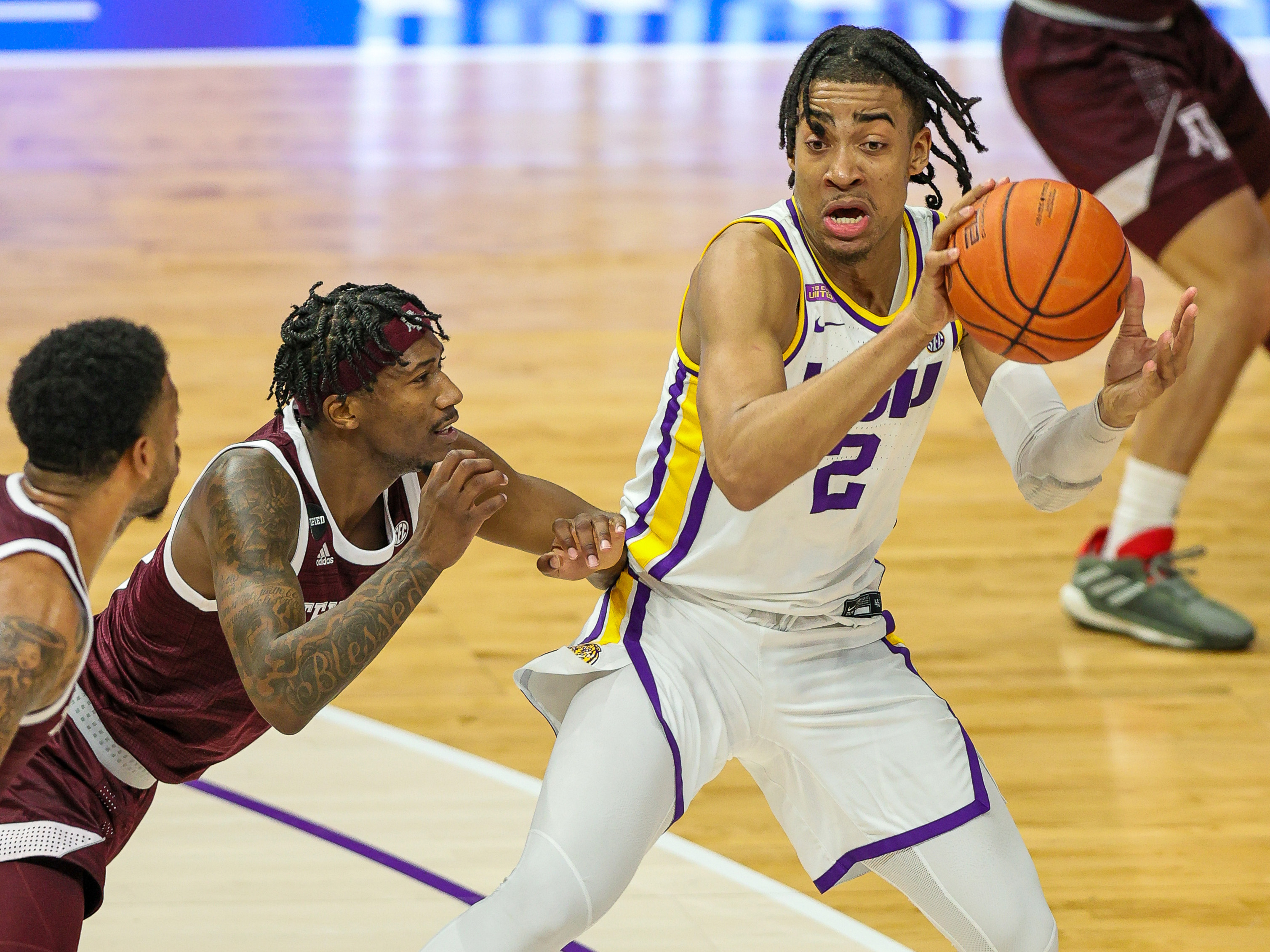 Dec 29, 2020; Baton Rouge, Louisiana, USA; LSU Tigers forward Trendon Watford (2) dribbles against Texas A&M Aggies guard Quenton Jackson (3) during the first half at the Pete Maravich Assembly Center.