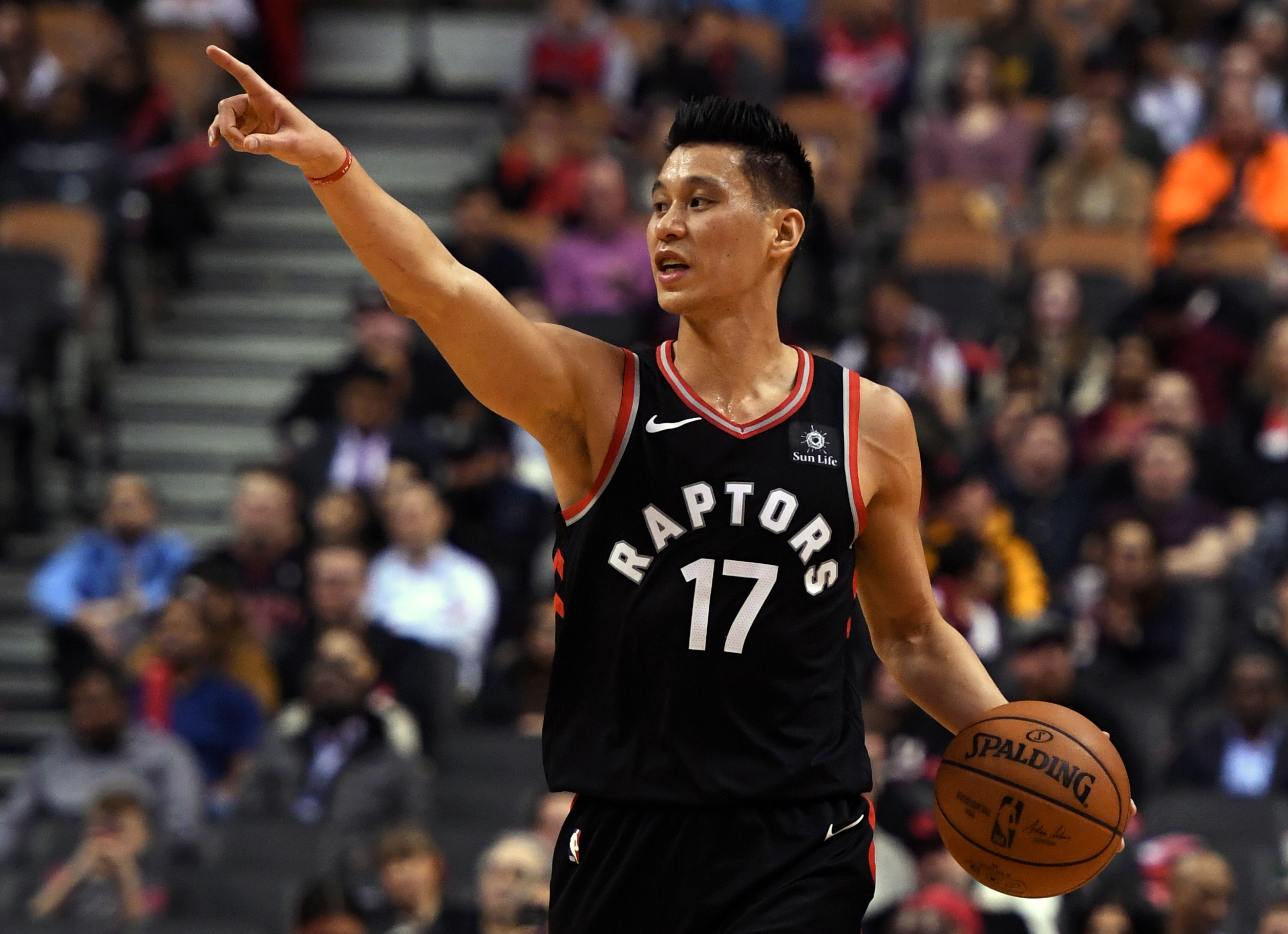 Mar 18, 2019; Toronto, Ontario, CAN; Toronto Raptors guard Jeremy Lin (17) gestures as he directs teammates in the second half against the New York Knicks at Scotiabank Arena. 