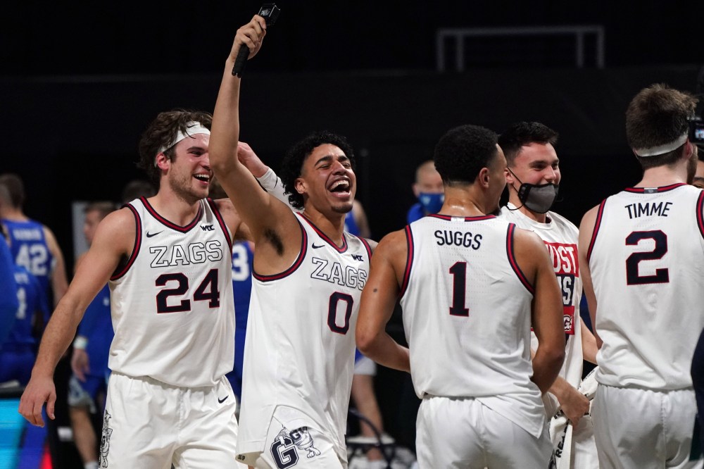 Mar 9, 2021; Las Vegas, NV, USA; Gonzaga Bulldogs forward Corey Kispert (24), guard Julian Strawther (0), guard Jalen Suggs (1) and forward Drew Timme (2) celebrate after defeating the the BYU Cougars in the West Coast Conference Tournament championship game at Orleans Arena.