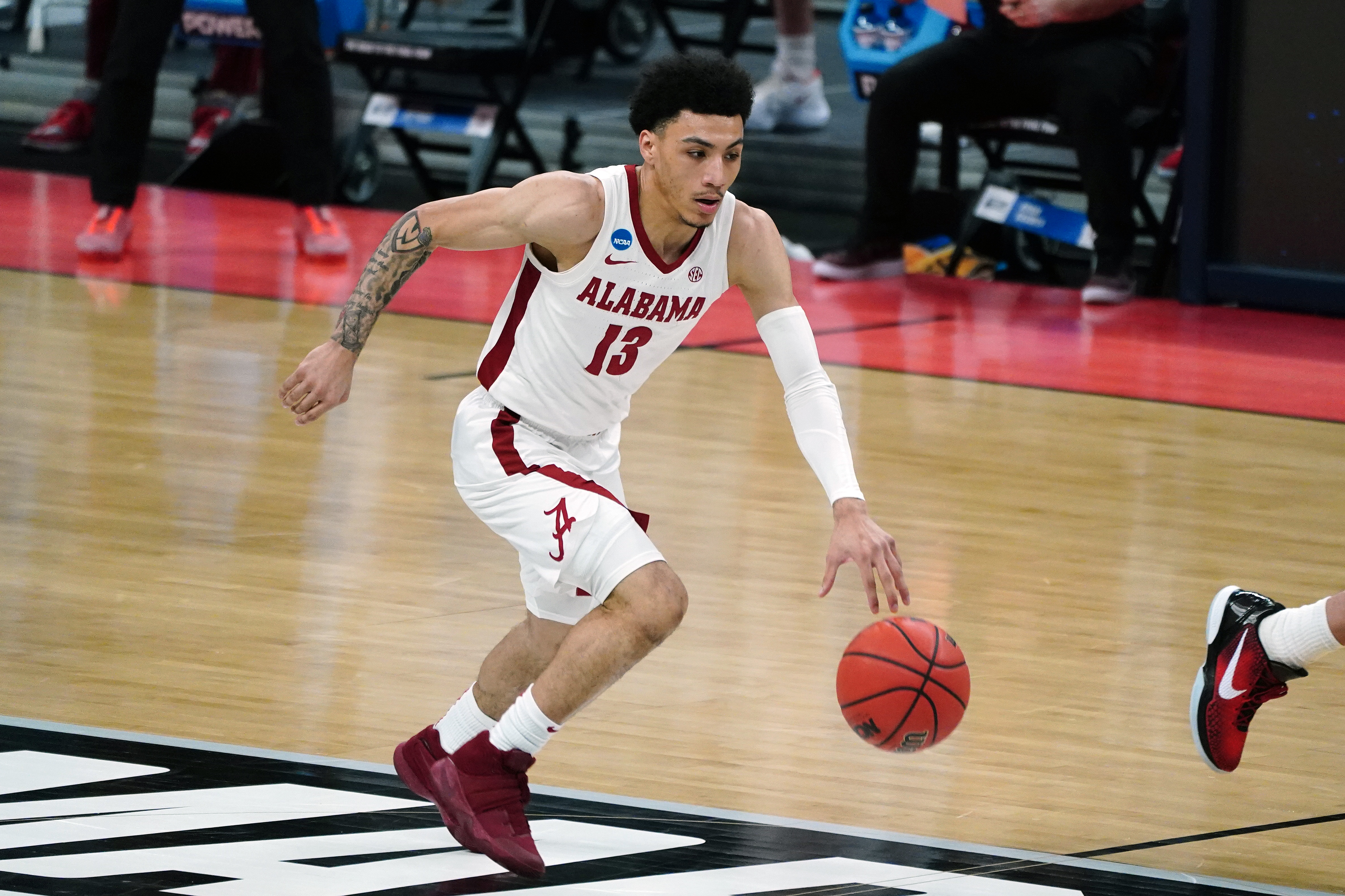 Mar 22, 2021; Indianapolis, Indiana, USA; Alabama Crimson Tide guard Jahvon Quinerly (13) drives against the Maryland Terrapins in the first half in the second round of the 2021 NCAA Tournament at Bankers Life Fieldhouse. 