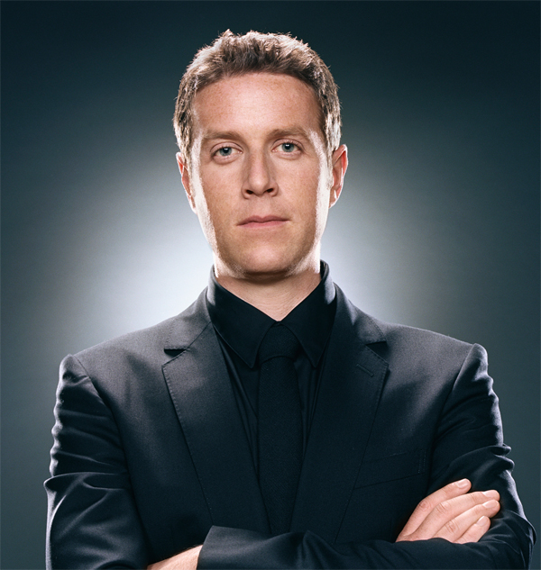 Geoff Keighley with arms folded looking at the camera
