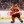 The Philadelphia Flyers mascot Gritty, wearing an orange and white Flyers jersey and carrying a white hockey stick, skates between periods at the Wells Fargo Center
