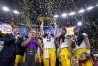 LSU quarterback Joe Burrow lifts the team's 2020 national championship trophy into the confetti-filled air at the Superdome.