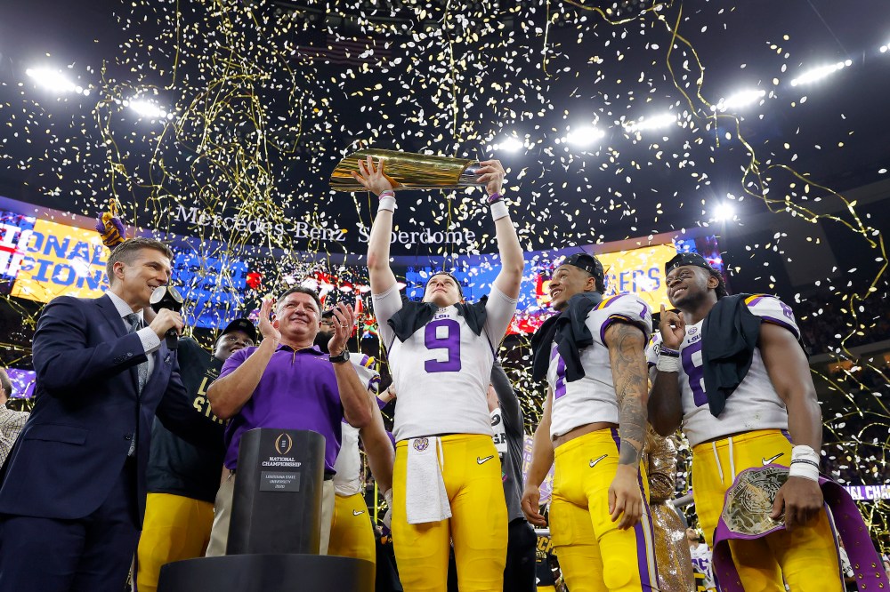 LSU quarterback Joe Burrow lifts the team's 2020 national championship trophy into the confetti-filled air at the Superdome.