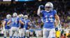 Detroit Lions wide receiver Amon-Ra St. Brown flexes his right arm in the end zone of Ford Field.