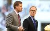 Joe Buck and Troy Aikman walking on a field together