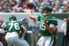 Joe Flacco throws from the pocket while George Fant blocks for him in the background.