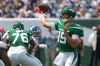 Joe Flacco throws from the pocket while George Fant blocks for him in the background.