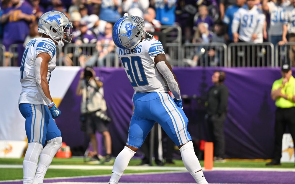 Sep 25, 2022; Minneapolis, Minnesota, USA; Detroit Lions wide receiver Amon-Ra St. Brown (14) and running back Jamaal Williams (30) react after a touchdown by Williams against the Minnesota Vikings during the first quarter at U.S. Bank Stadium.