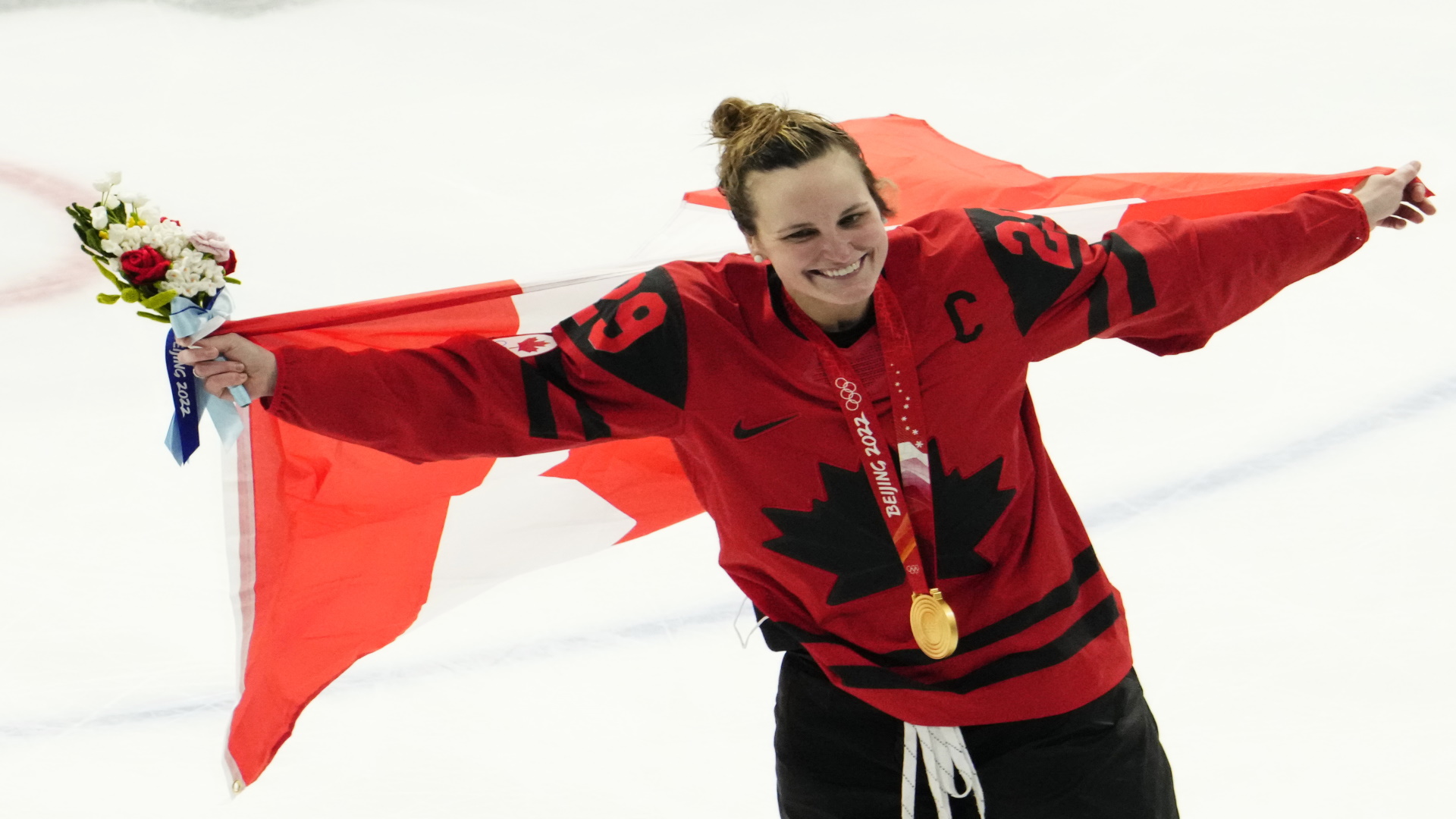 NHL 23 top-rated women's league players: Marie-Philip Poulin holds a Canadian flag