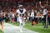Michael Thomas celebrates a touchdown by gesturing with his arms on the edge of the end zone. 