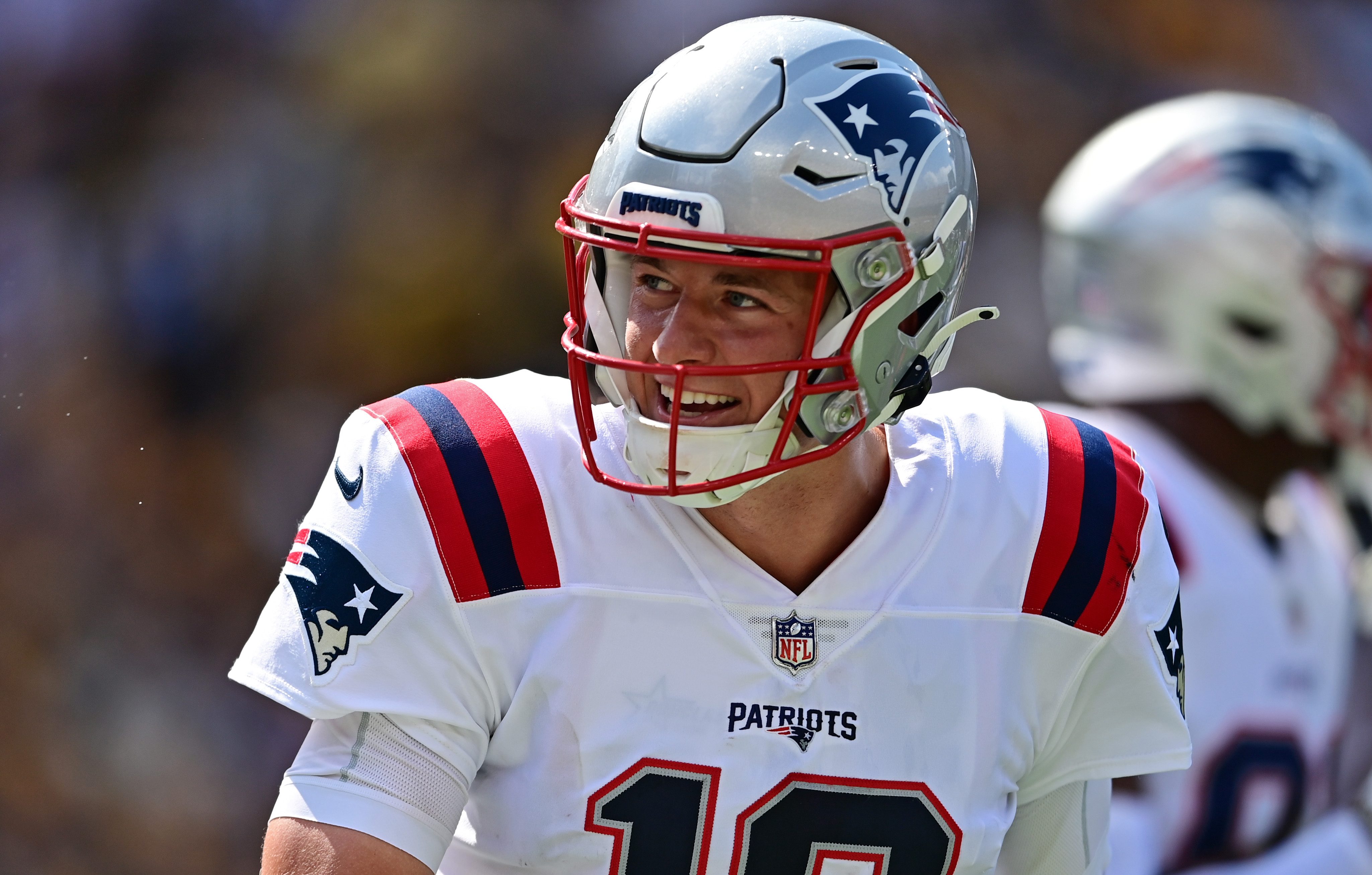 Sep 18, 2022; Pittsburgh, Pennsylvania, USA; New England Patriots quarterback Mac Jones (10) smiles after a touchdown by running back Damien Harris (37) during the third quarter against the Pittsburgh Steelers at Acrisure Stadium.