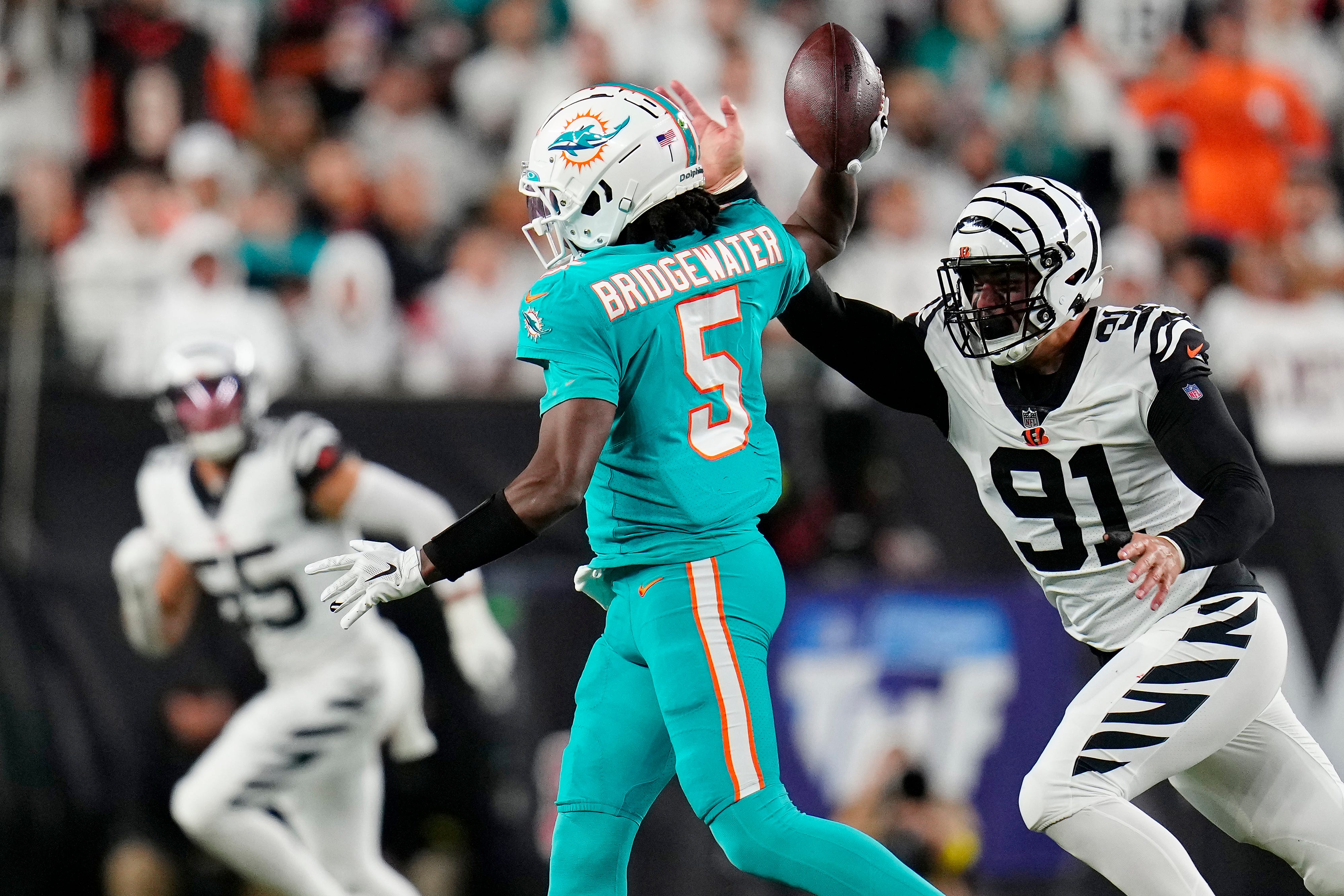 Cincinnati Bengals defensive end Trey Hendrickson (91) nearly strips the ball from Miami Dolphins quarterback Teddy Bridgewater (5) as he scrambles in the second quarter of the NFL Week 4 game between the Cincinnati Bengals and the Miami Dolphins at PayCor Stadium in downtown on Thursday, Sept. 29, 2022. The Bengals 14-12 at halftime.
