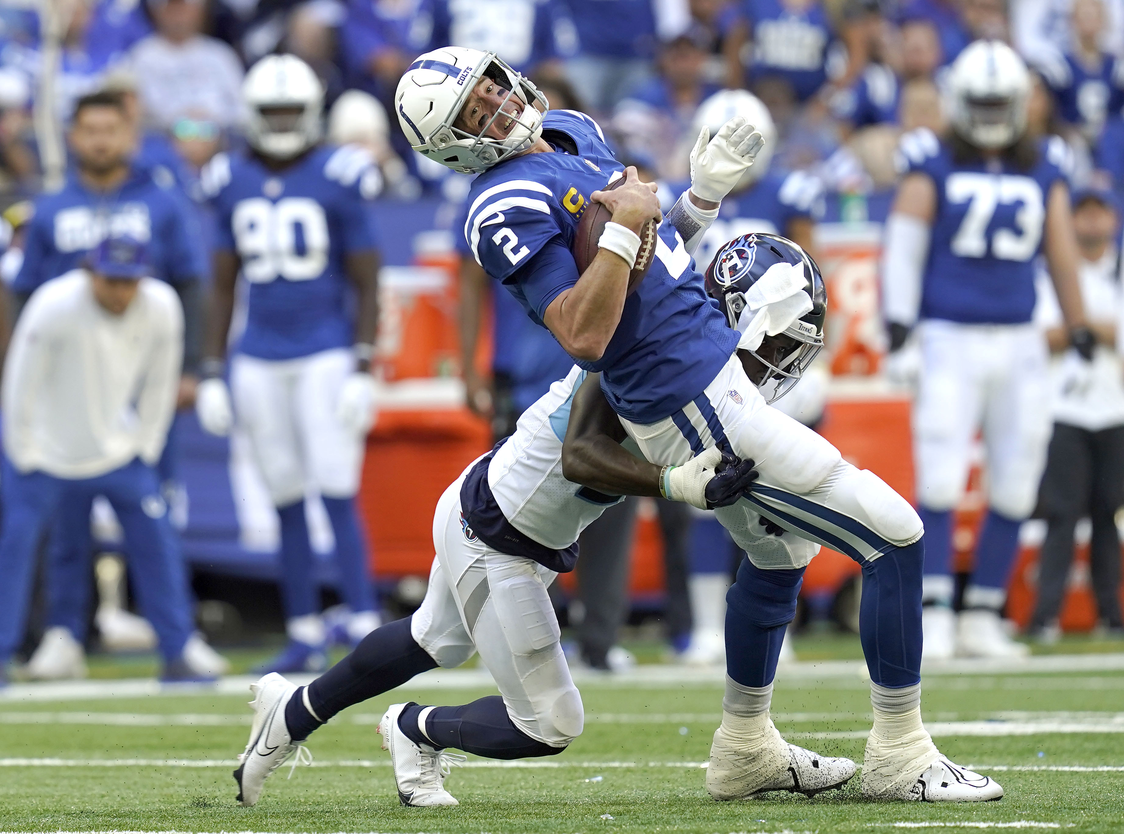 Oct 2, 2022; Indianapolis, Indiana, USA; Tennessee Titans cornerback Roger McCreary (21) tackles Indianapolis Colts quarterback Matt Ryan (2) during the first half at Lucas Oil Stadium. 