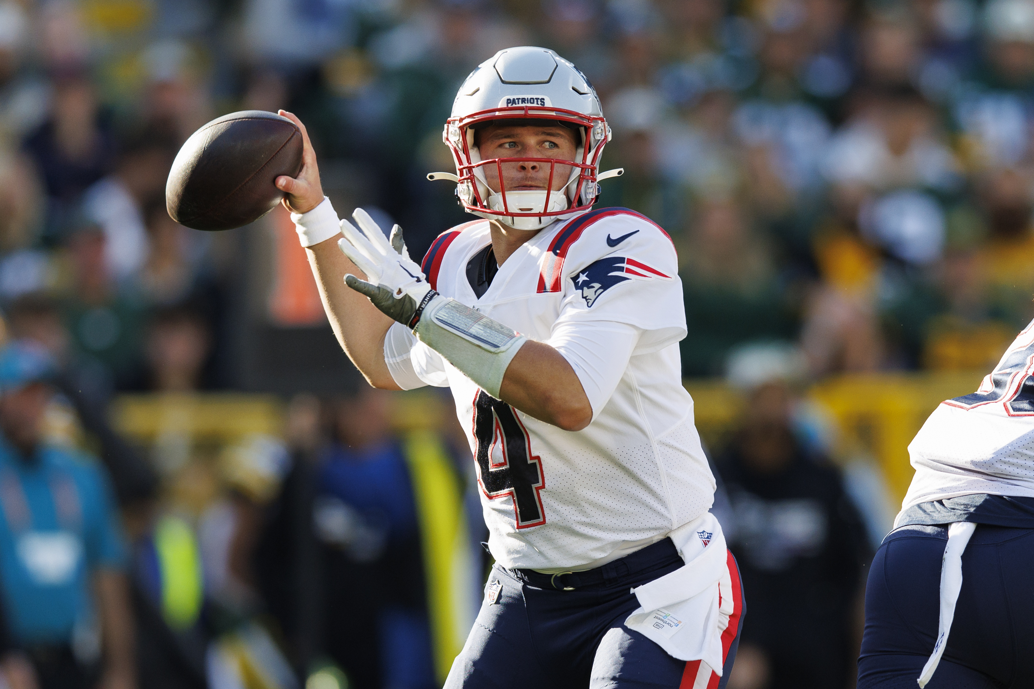 Oct 2, 2022; Green Bay, Wisconsin, USA; New England Patriots quarterback Bailey Zappe (4) throws a pass during the second quarter against the Green Bay Packers at Lambeau Field. 