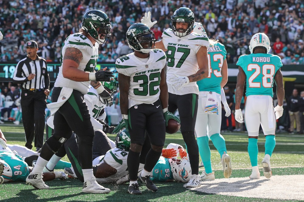 Oct 9, 2022; East Rutherford, New Jersey, USA; New York Jets running back Michael Carter (32) celebrates after scoring a touchdown against the Miami Dolphins during the second half at MetLife Stadium.