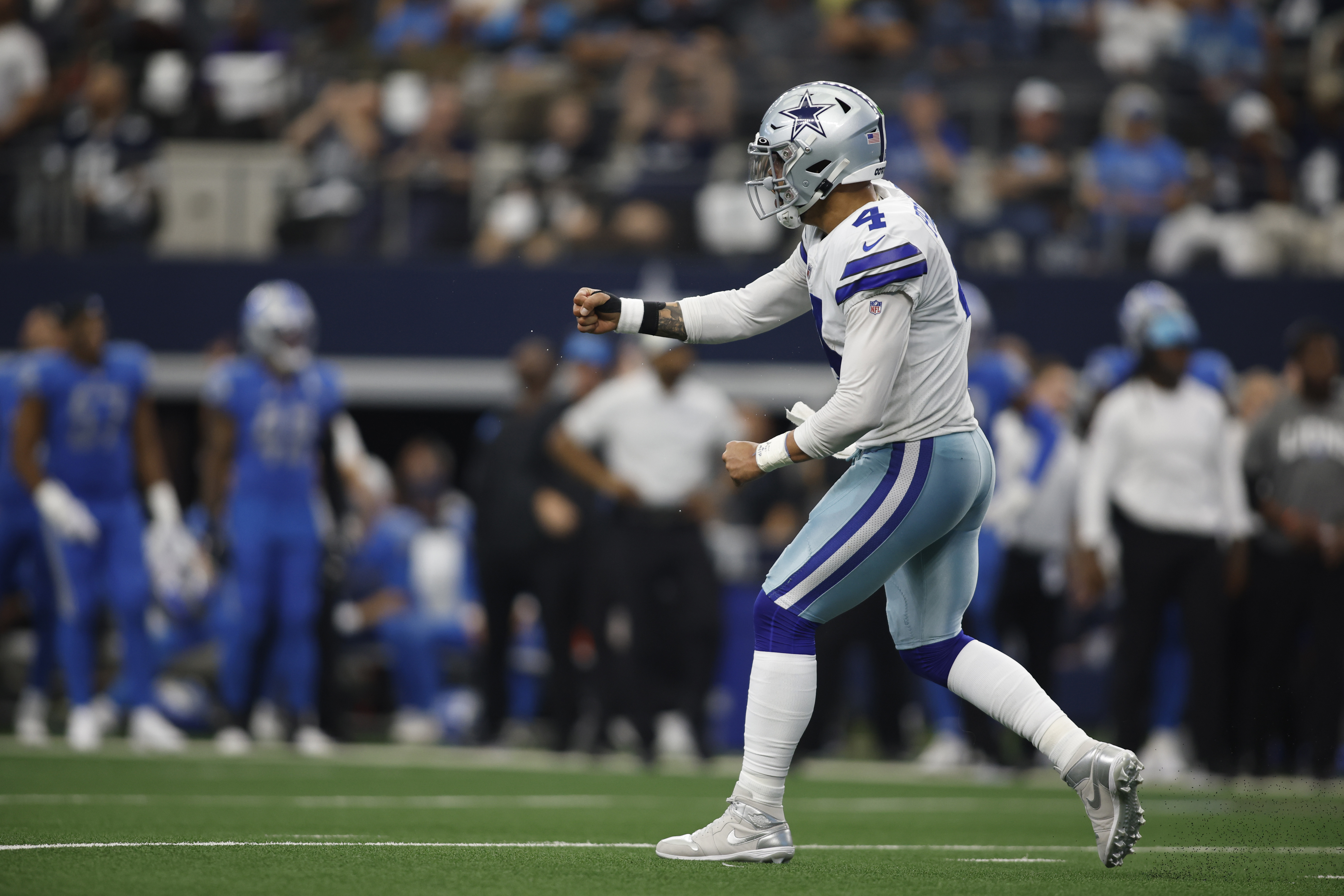 Oct 23, 2022; Arlington, Texas, USA; Dallas Cowboys quarterback Dak Prescott (4) celebrates throwing a touchdown pass in the fourth quarter against the Detroit Lions at AT&T Stadium.