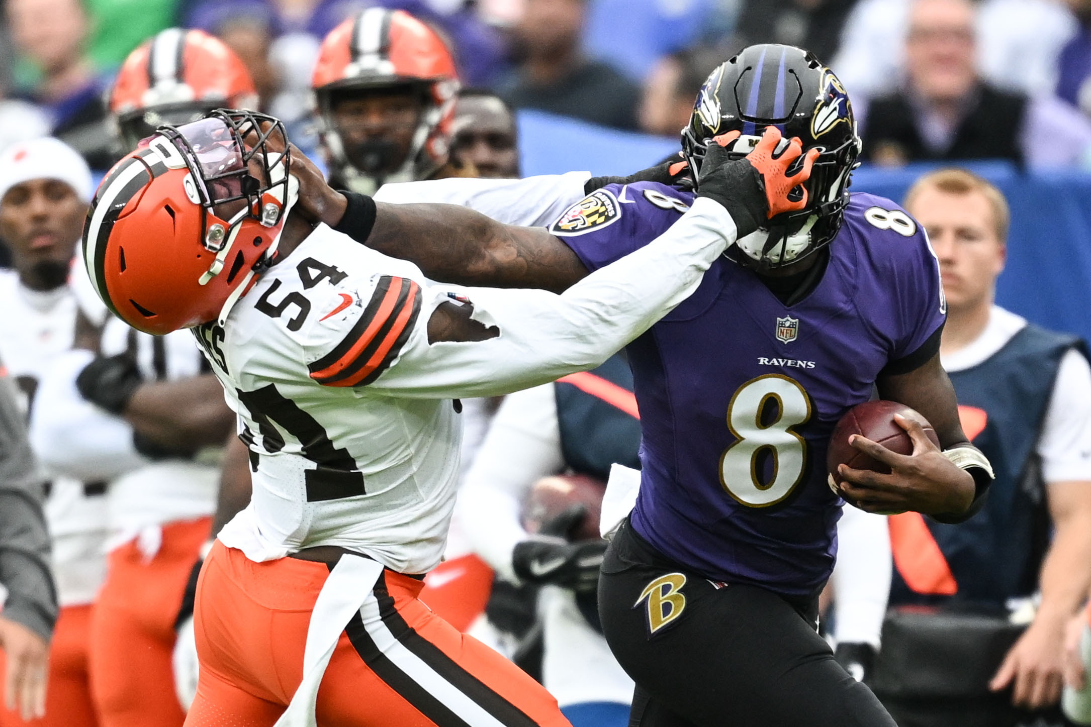 Oct 23, 2022; Baltimore, Maryland, USA; Baltimore Ravens quarterback Lamar Jackson (8) stiff arms Cleveland Browns linebacker Deion Jones (54) during the fourth quarter at M&T Bank Stadium.