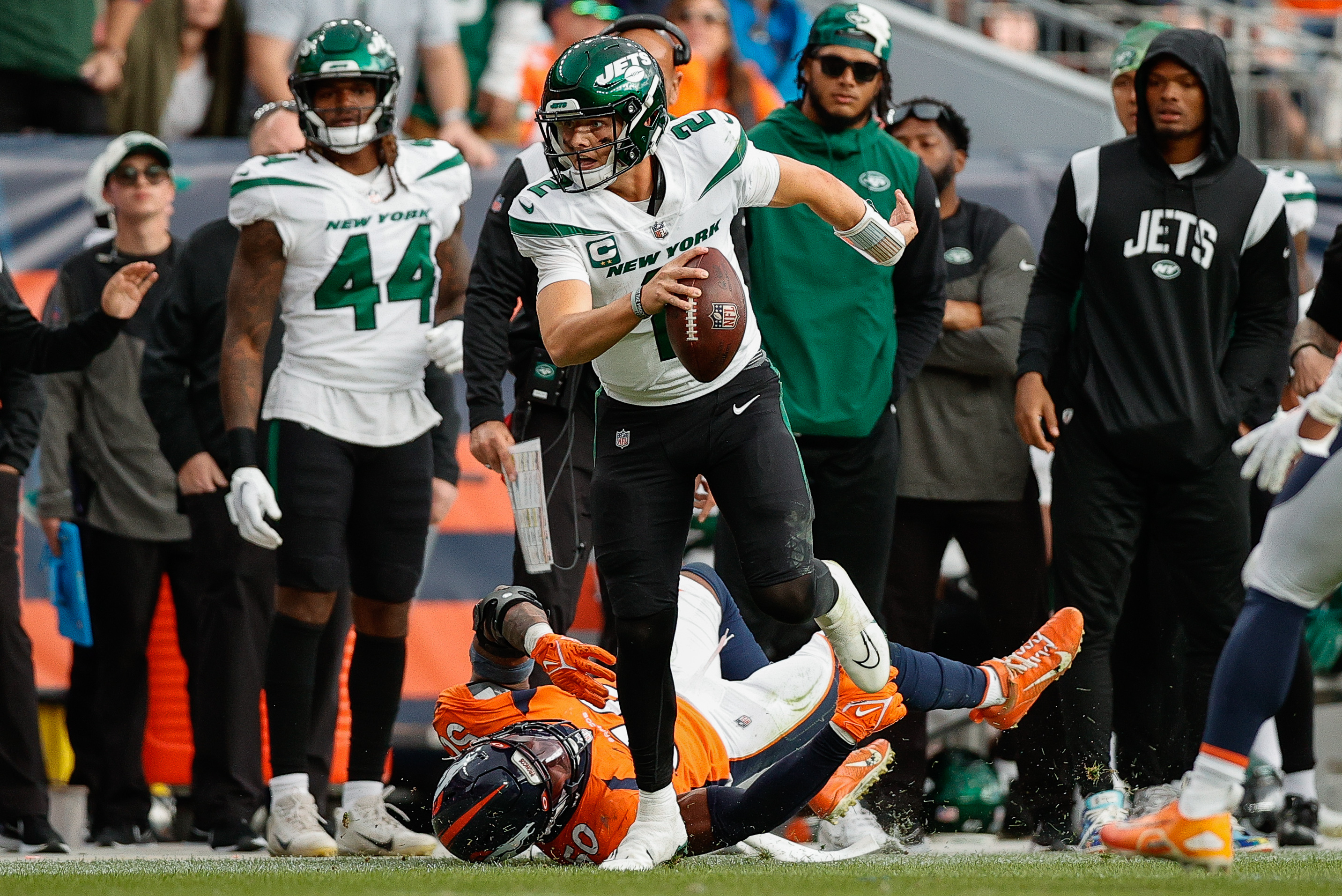 Oct 23, 2022; Denver, Colorado, USA; New York Jets quarterback Zach Wilson (2) runs through the tackle of Denver Broncos linebacker Jonas Griffith (50) in the fourth quarter at Empower Field at Mile High.