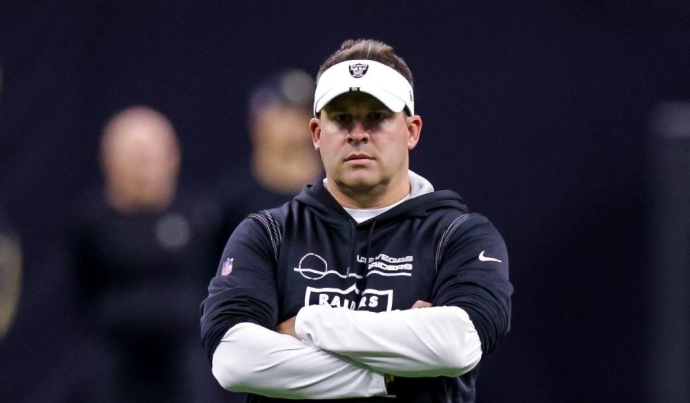 Josh McDaniels crossing his arms during a 2022 Raiders game