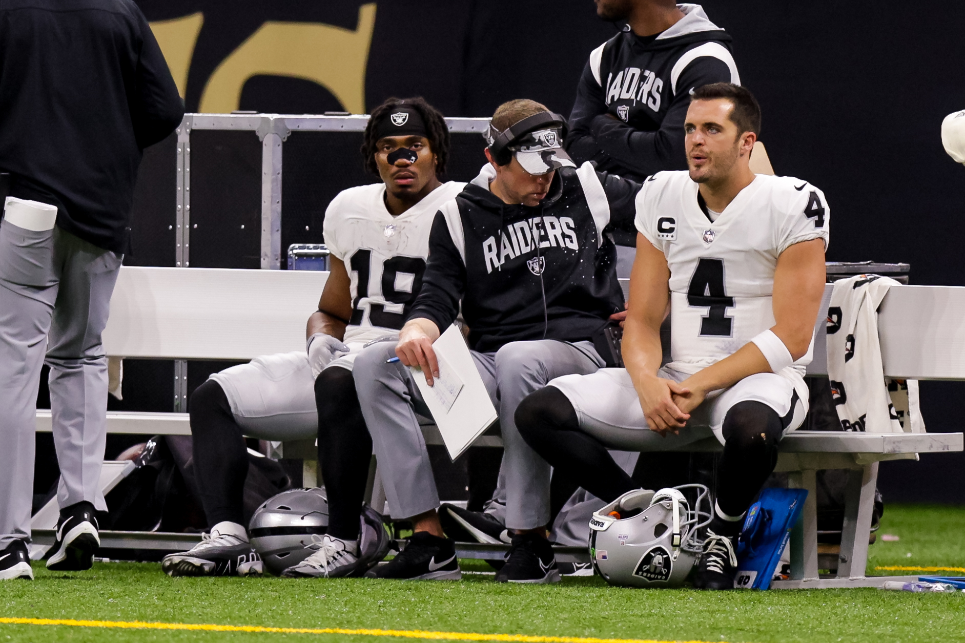Oct 30, 2022; New Orleans, Louisiana, USA; Las Vegas Raiders quarterback Derek Carr (4) and Las Vegas Raiders wide receiver DJ Turner (19) sit on the bench against the New Orleans Saints during the first half at Caesars Superdome. 