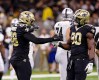 Oct 30, 2022; New Orleans, Louisiana, USA; New Orleans Saints defensive end Payton Turner (98) and New Orleans Saints defensive end Tanoh Kpassagnon (90) react to sacking Las Vegas Raiders quarterback Jarrett Stidham (3) during the second half at Caesars Superdome.