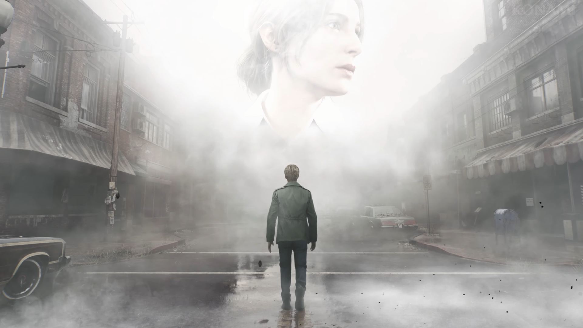 Silent Hill 2 and other announcements from the Silent Hill stream: A woman's face appears above a fog bank that covers an abandoned main street