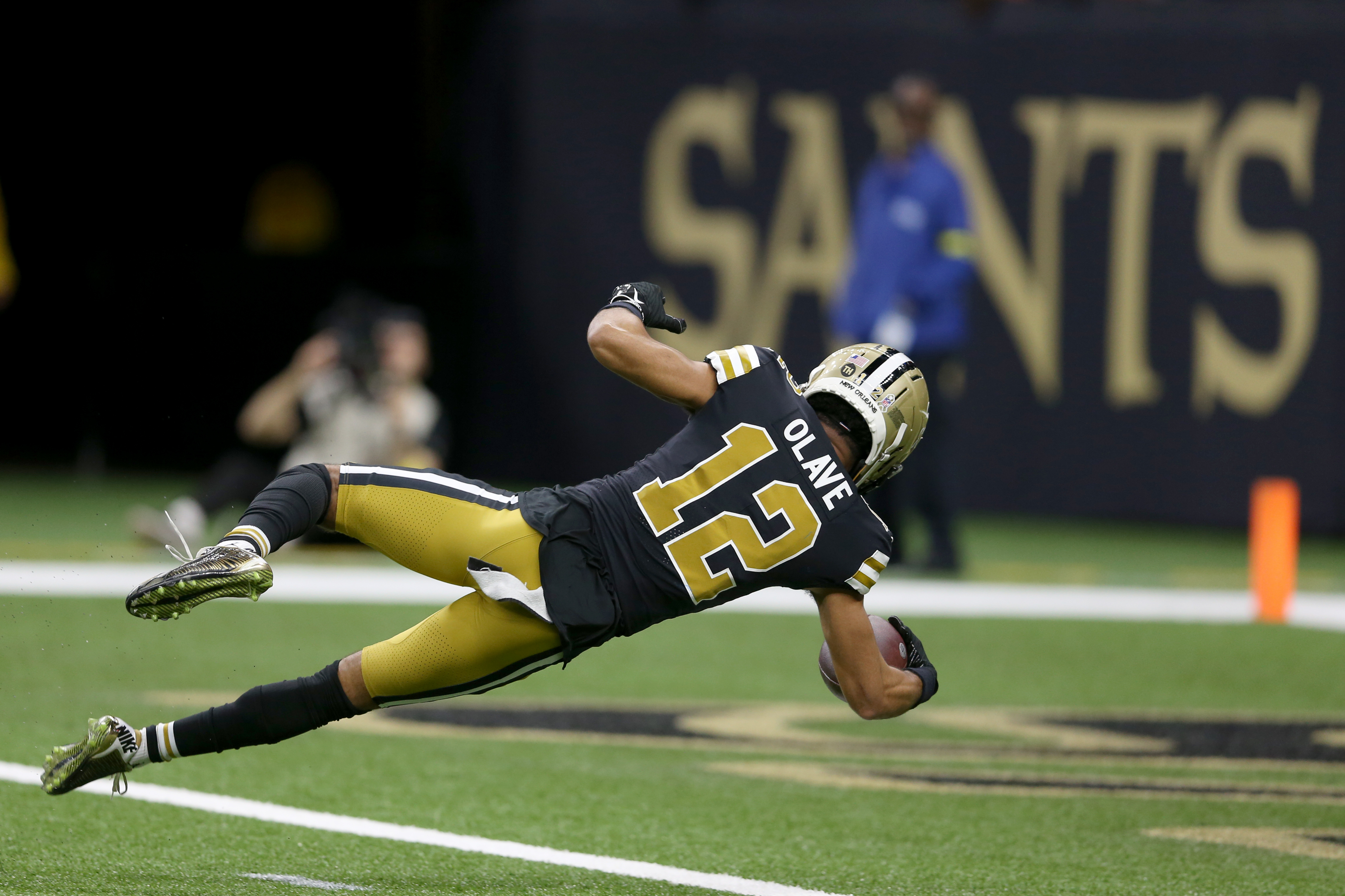 Nov 20, 2022; New Orleans, Louisiana, USA; New Orleans Saints wide receiver Chris Olave (12) dives into the end zone for a touchdown in the second half against the Los Angeles Rams at the Caesars Superdome. 