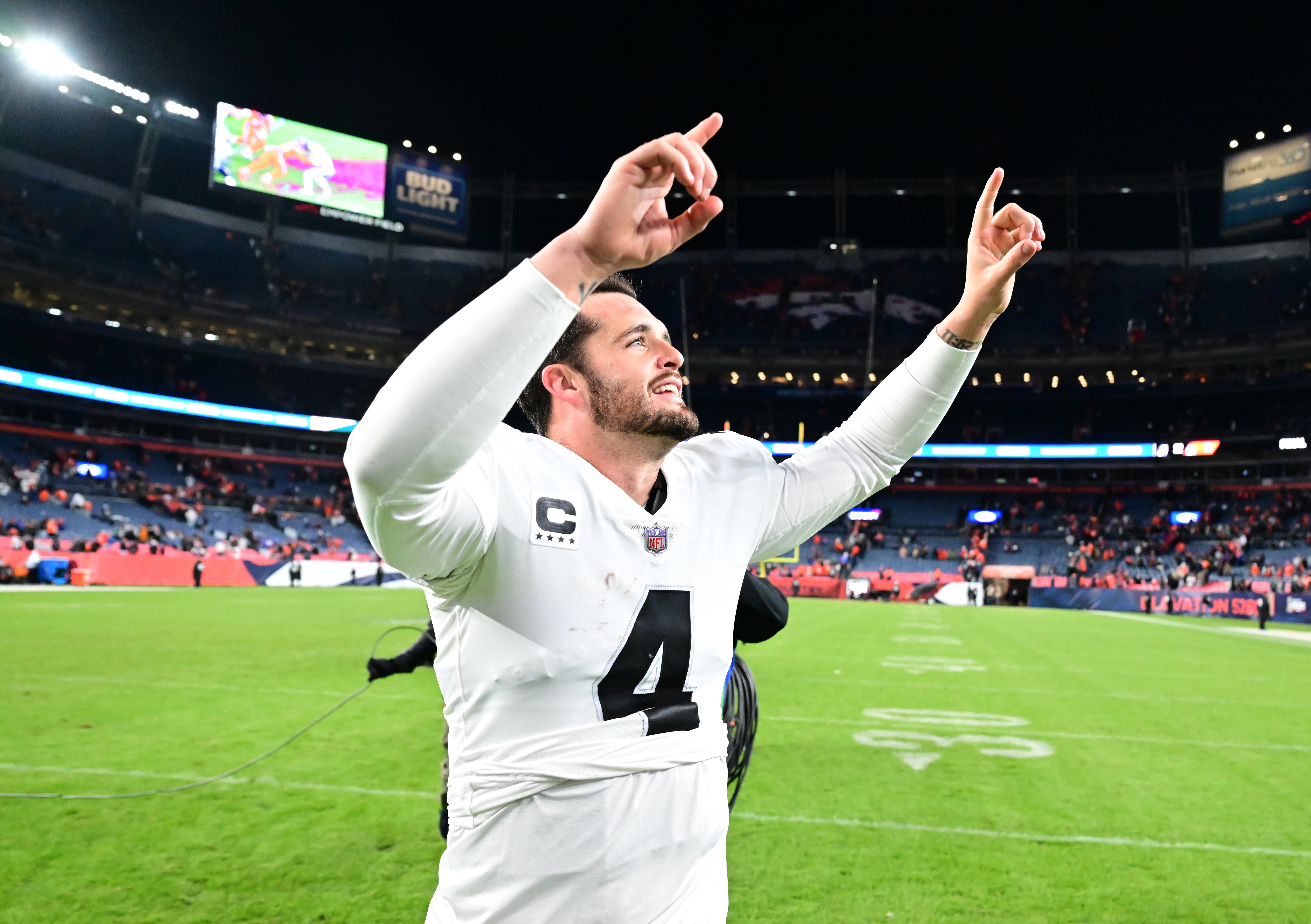 Nov 20, 2022; Denver, Colorado, USA; Las Vegas Raiders quarterback Derek Carr (4) celebrates the overtime win over the Denver Broncos at Empower Field at Mile High. 