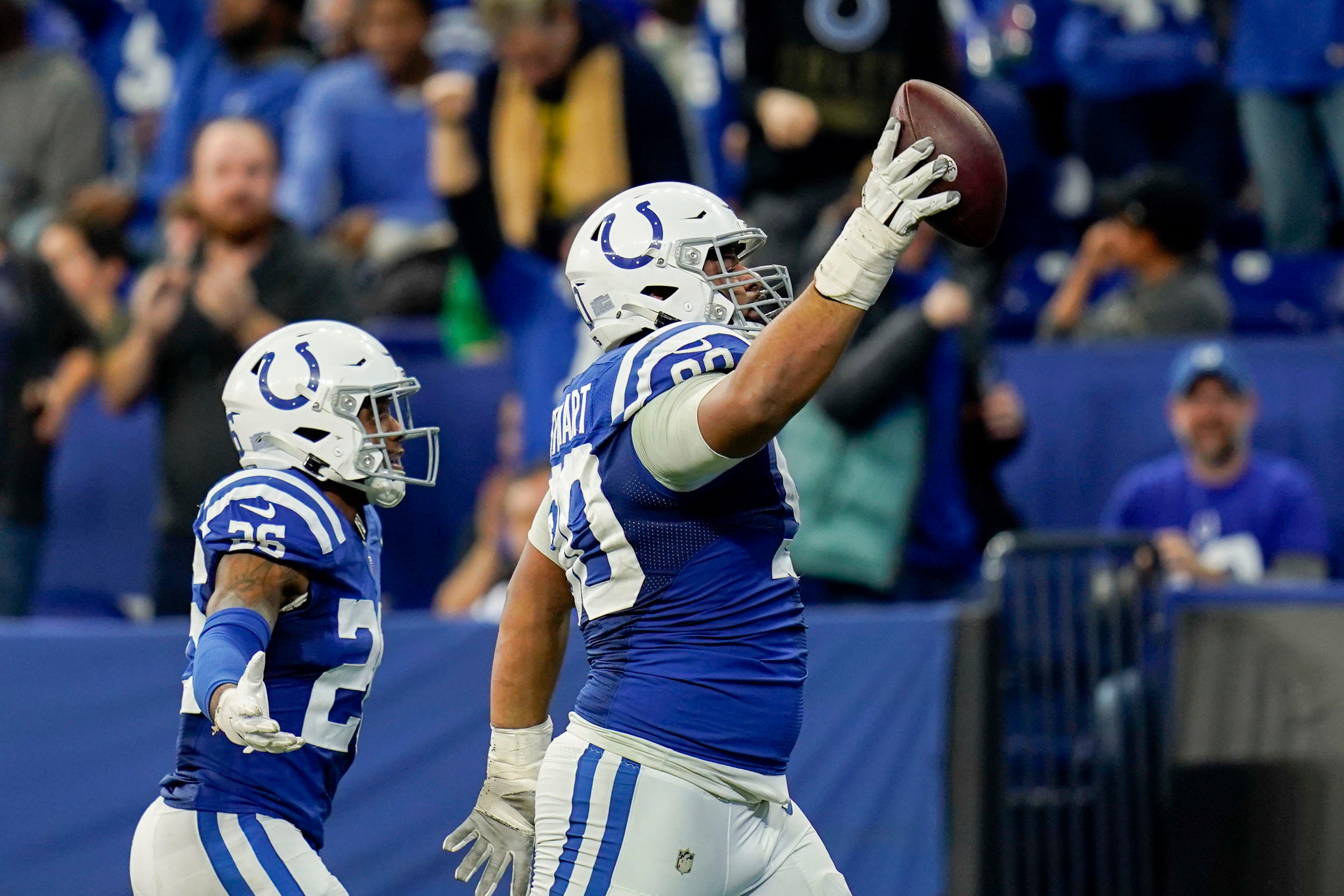 Indianapolis Colts defensive tackle Grover Stewart (90) and Indianapolis Colts safety Rodney McLeod Jr. (26) celebrate after recovering a fumble Sunday, Nov. 20, 2022, during a game against the Philadelphia Eagles at Lucas Oil Stadium in Indianapolis.