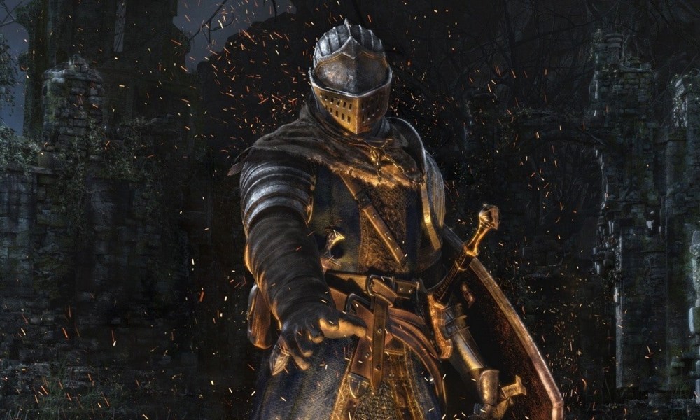 Dark Souls PC online functions are up again at last - for now: A man wearing silver armor stands with his hand over a cloud of sparks