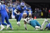 Dec 4, 2022; Detroit, Michigan, USA; Detroit Lions running back D'Andre Swift (32) leaps through a hole in the line past Jacksonville Jaguars linebacker Arden Key (49) in the fourth quarter at Ford Field.