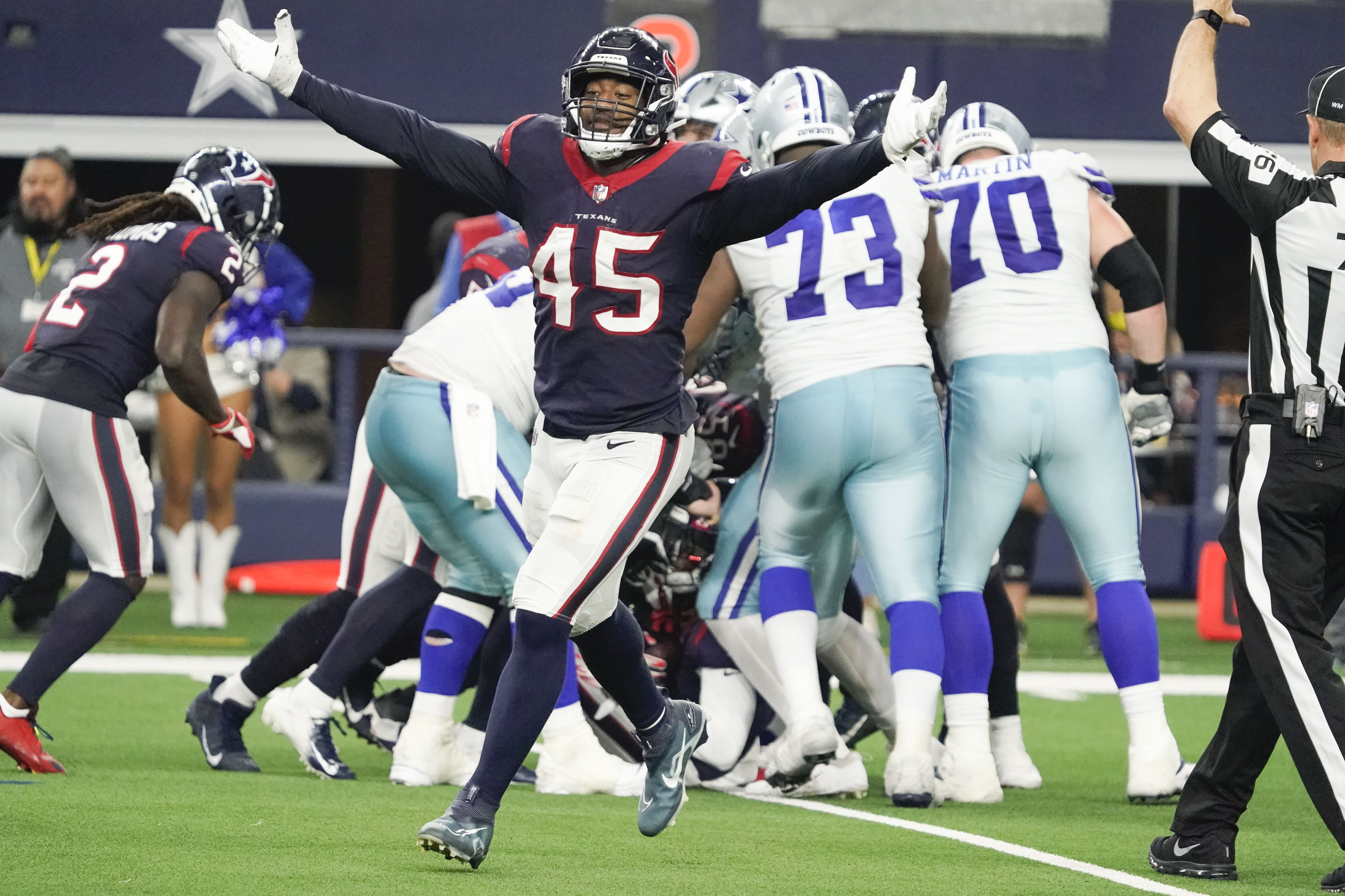 Dec 11, 2022; Arlington, Texas, USA; Houston Texans linebacker Ogbonnia Okoronkwo (45) reacts after a turnover by the Dallas Cowboys during the second half at AT&T Stadium.