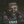 Idris Elba stars in Cyberpunk 2077 DLC Phantom Liberty: A man wearing a dark brown jacket is illuminated through slatted blinds. He wears a solemn expression on his face