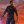 EA announces Star Wars Jedi Survivor release date at The Game Awards: An animated white man in a tattered grey tunic and pants is holding a blade made of blue light. He stands depicted against a twilit background