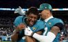 JACKSONVILLE, FLORIDA - JANUARY 14: Zay Jones #7 and Evan Engram #17 of the Jacksonville Jaguars celebrate on the field after defeating the Los Angeles Chargers 31-30 in the AFC Wild Card playoff game at TIAA Bank Field on January 14, 2023 in Jacksonville, Florida.
