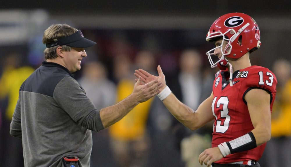 Jan 9, 2023; Inglewood, CA, USA; Georgia Bulldogs quarterback Stetson Bennett (13) is greeted by head coach Kirby Smart as he comes out of the game in the 4th quarter against the TCU Horned Frogs in the CFP national championship game at SoFi Stadium.