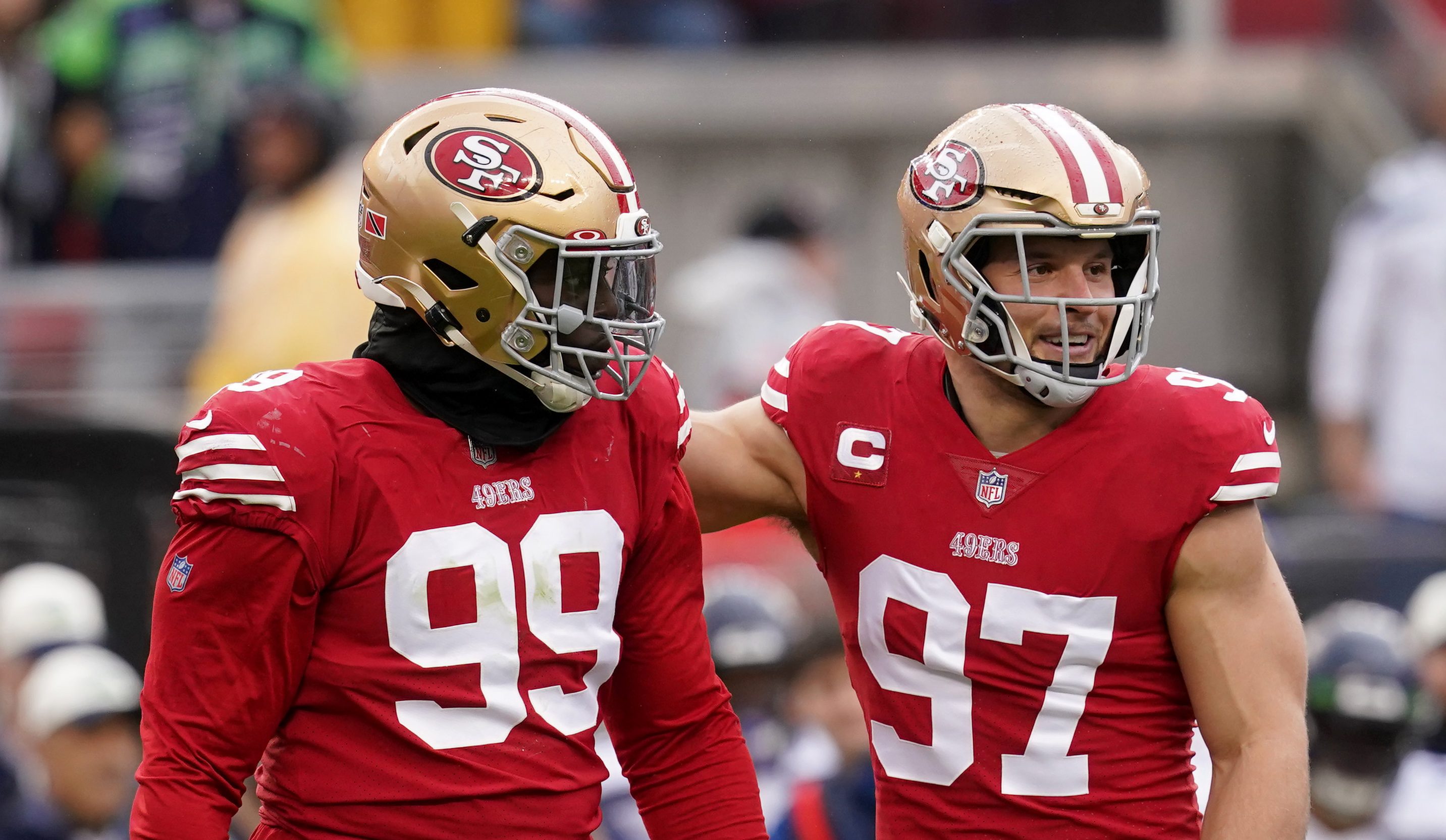Jan 14, 2023; Santa Clara, California, USA; San Francisco 49ers defensive tackle Javon Kinlaw (99) and defensive end Nick Bosa (97) react after a play in the first quarter during a wild card game against the Seattle Seahawks at Levi's Stadium.
