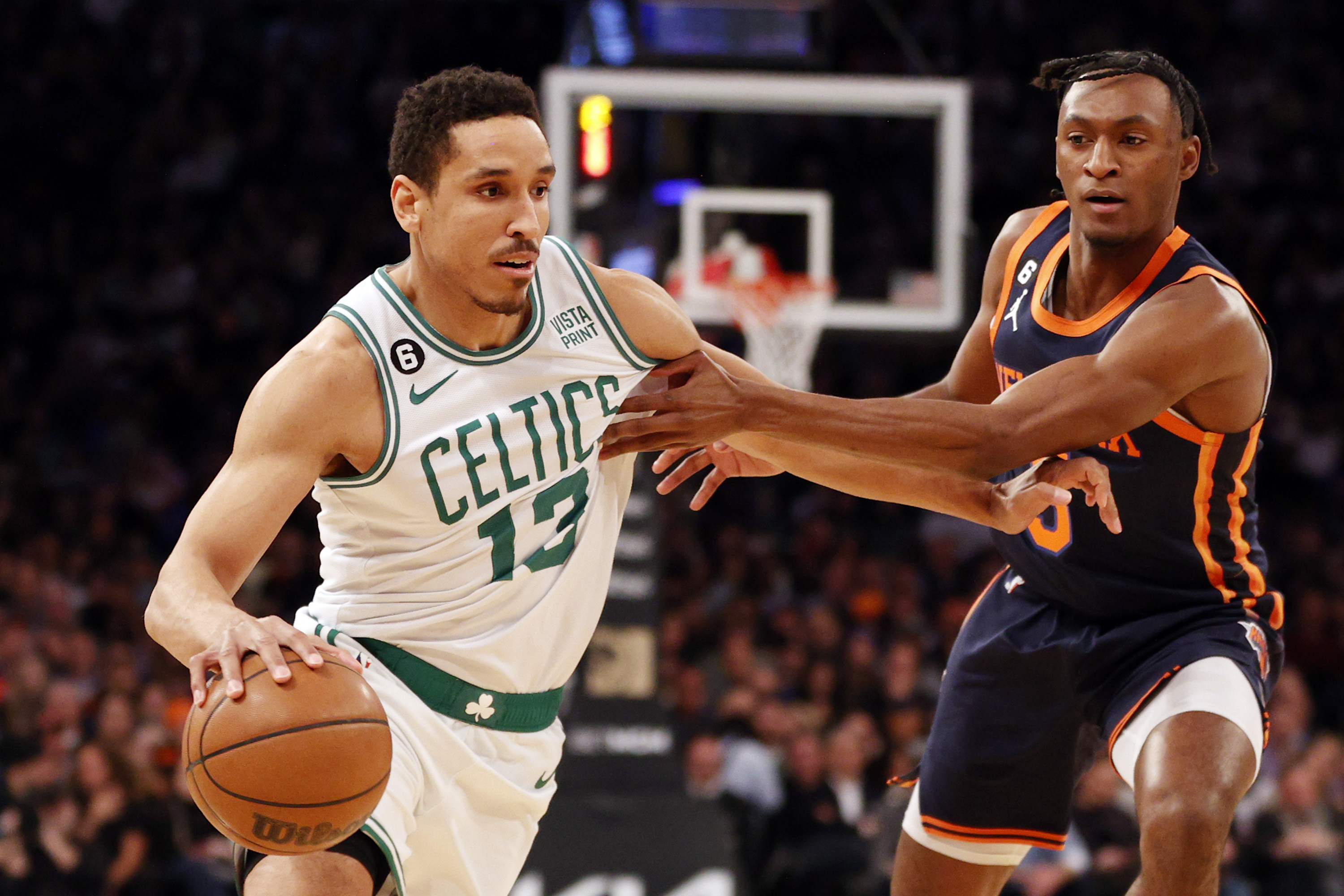 Malcolm Brogdon #13 of the Boston Celtics dribbles against Immanuel Quickley #5 of the New York Knicks during the first half at Madison Square Garden on February 27, 2023 in New York City.