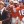 gene hackman stands in front of a group of football players in orange jerseys during a scene from the replacements