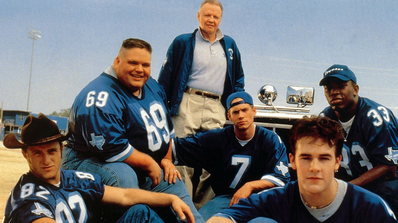 group of men in blue football jerseys in a promotional photo from varsity blues