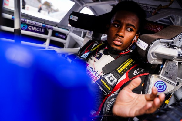 NASCAR driver Rajah Caruth sits in his truck before a race