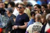 Gordon Ramsay wears a dark shirt and sunglasses on the sideline at the Super Bowl