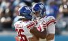 Oct 23, 2022; Jacksonville, Florida, USA; New York Giants quarterback Daniel Jones (8) celebrates with teammate running back Saquon Barkley (26) after scoring a touchdown against the Jacksonville Jaguars during the fourth quarter at TIAA Bank Field.
