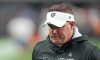 Josh McDaniels with a sad face walking off the field after a Raiders loss in 2022.