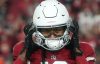 DeAndre Hopkins holds his fingers to his helmet while looking at the camera during a Christmas 2022 Cardinals game.