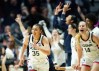 UConn Huskies guard Azzi Fudd, wearing a white jersey, reacts after a 3-pointer.