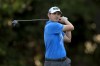 Patrick Cantlay holding his backstroke after striking a golf ball.